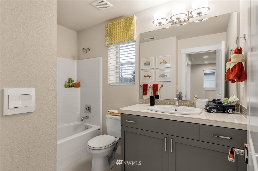 23118 88th Avenue West, Unit 3 Edmonds, WA 98026 - Photo 31 of 31 a bathroom with a double vanity sink mirror and toilet