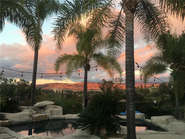a living room with furniture a rug and a chandelier