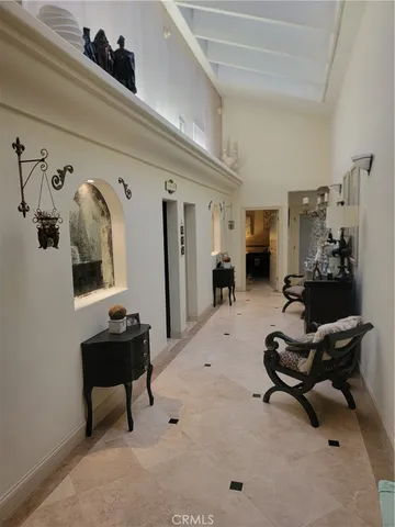 a bedroom with a bed couch table and flat screen tv