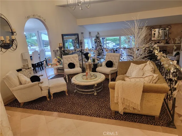 a living room with furniture a flat screen tv and a floor to ceiling window