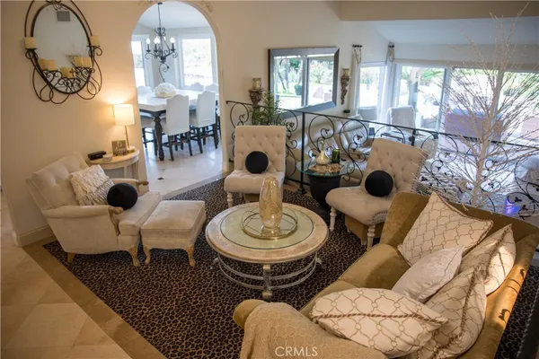 a view of a patio with a dining table and chairs under an umbrella with a barbeque