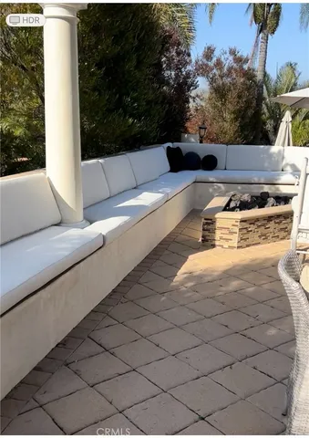 a view of a kitchen with stainless steel appliances kitchen island granite countertop a table and chairs in it