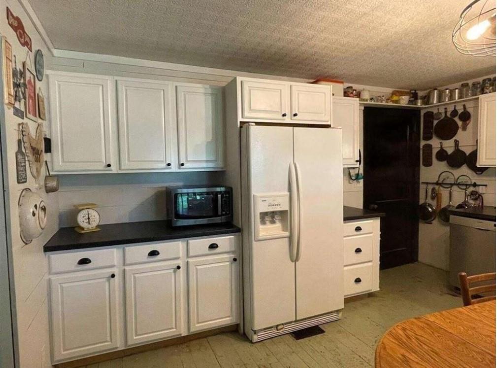 97 Sycamore Street Rockmart, GA 30153 - Photo 5 of 7 a kitchen with stainless steel appliances white cabinets and a refrigerator