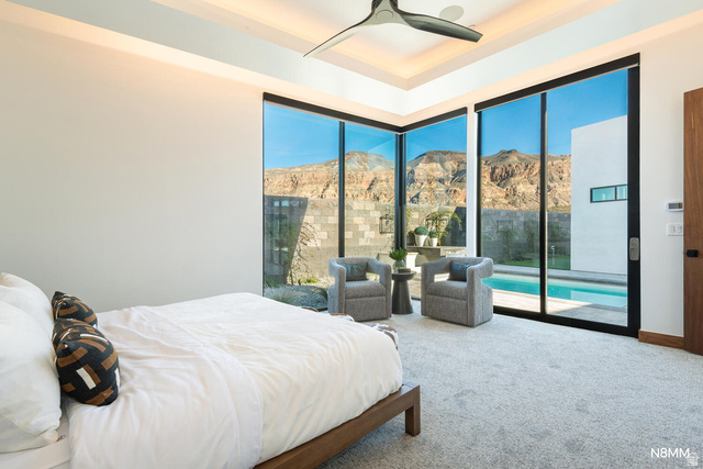 3607 South Cypress Pt Road Hurricane, UT 84737 - Photo 33 of 59 Bedroom featuring carpet flooring, a mountain view, ceiling fan, access to the pool area, and a raised ceiling