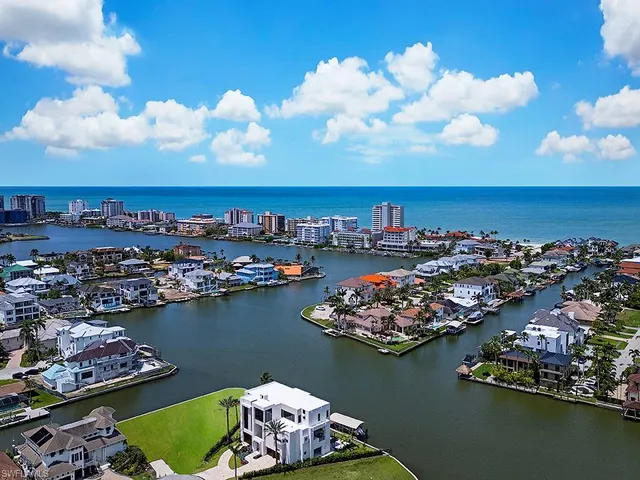 an aerial view of a houses with ocean view