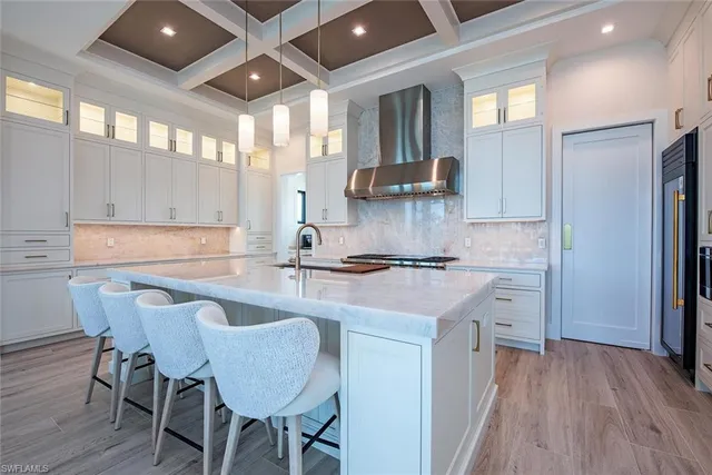 a kitchen with stainless steel appliances granite countertop a sink and a refrigerator