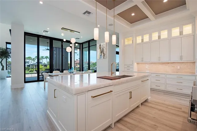 a large white bathroom with a large tub and sink