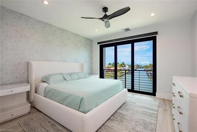 a bedroom with a large bed and a large window