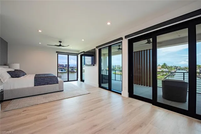 a spacious bedroom with a large bed and a large window