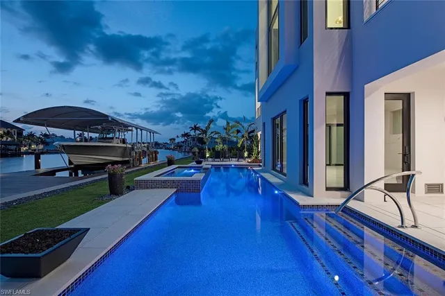 a view of a patio with swimming pool table and chairs