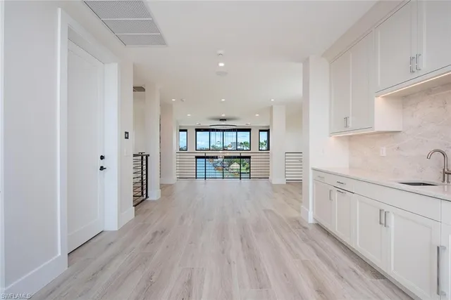 a view of a kitchen with wooden floor and a window