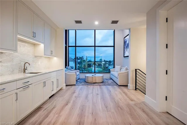a large white kitchen with a large window