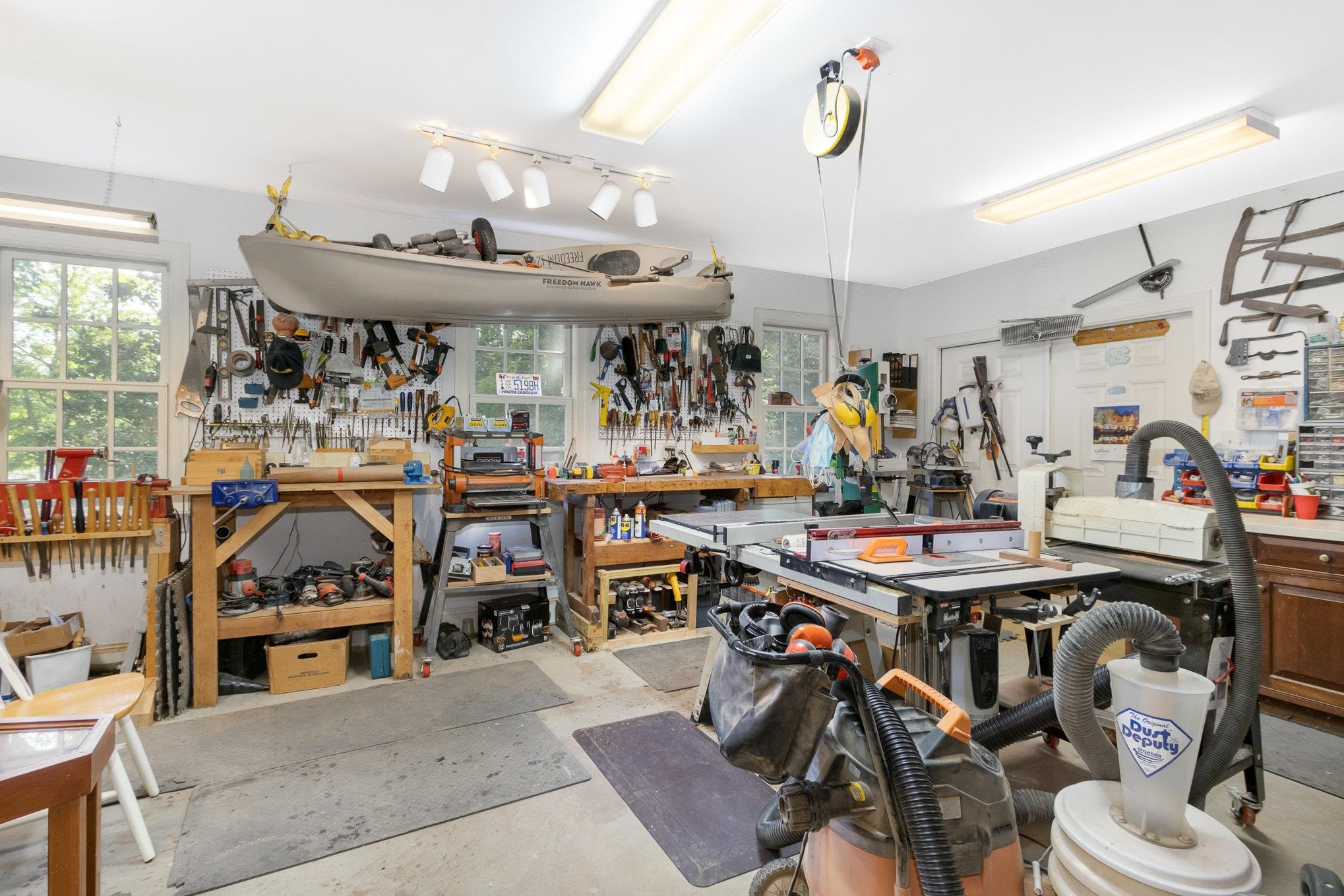 3327 Landor Road Raleigh, NC 27609 - Photo 52 of 60 Terrific space for woodworking with plenty of windows with a door that walks out to the back yard with an additional Utility Room used for storage beside the patio. Workshop