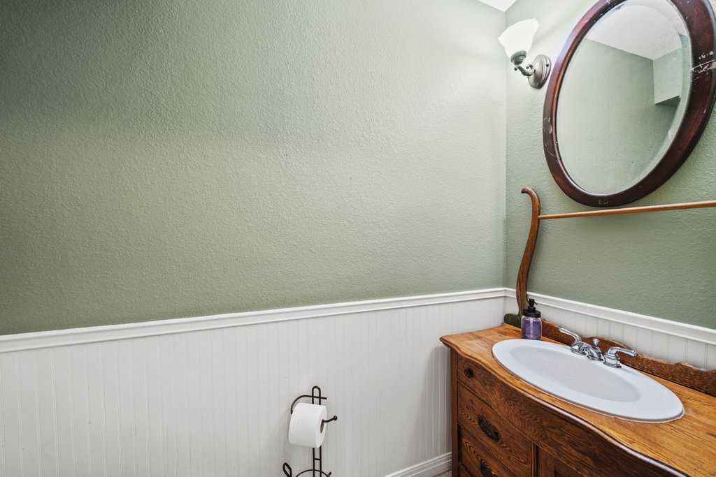 1100 Martindale Falls Road Martindale, TX 78655 - Photo 11 of 31 Bathroom with wainscoting, vanity, and a textured wall
