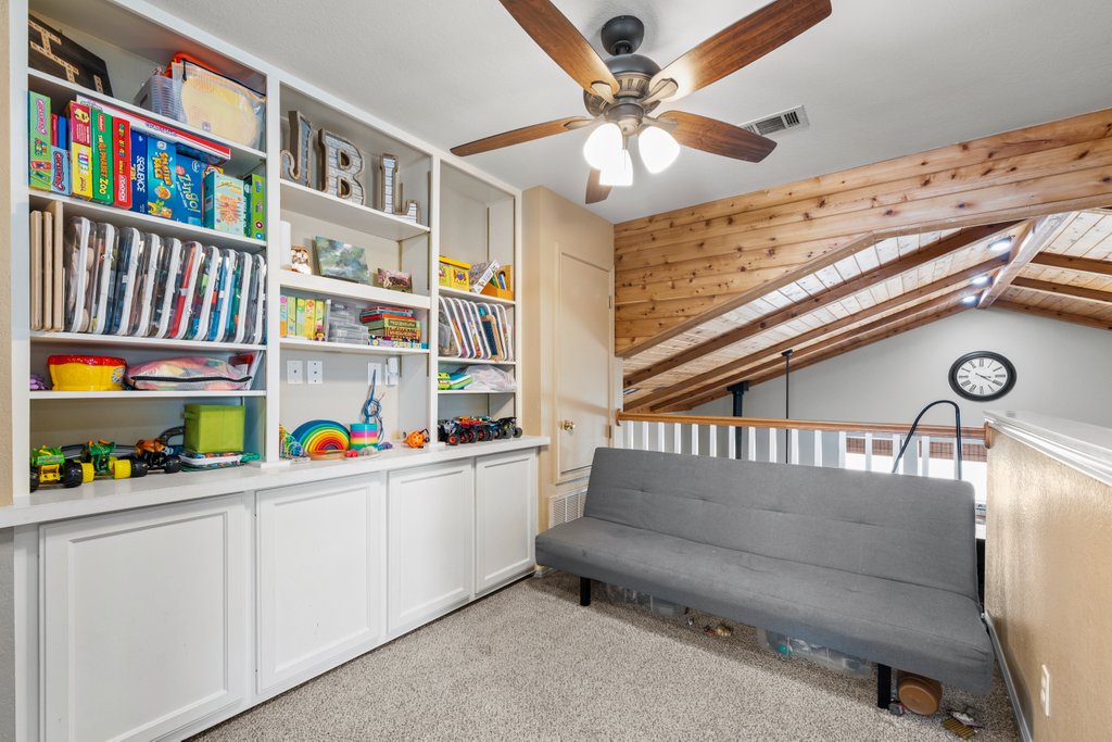 1100 Martindale Falls Road Martindale, TX 78655 - Photo 13 of 31 Living area featuring lofted ceiling, light colored carpet, and a ceiling fan