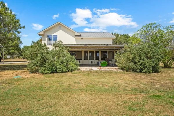 a view of house with yard and swimming pool