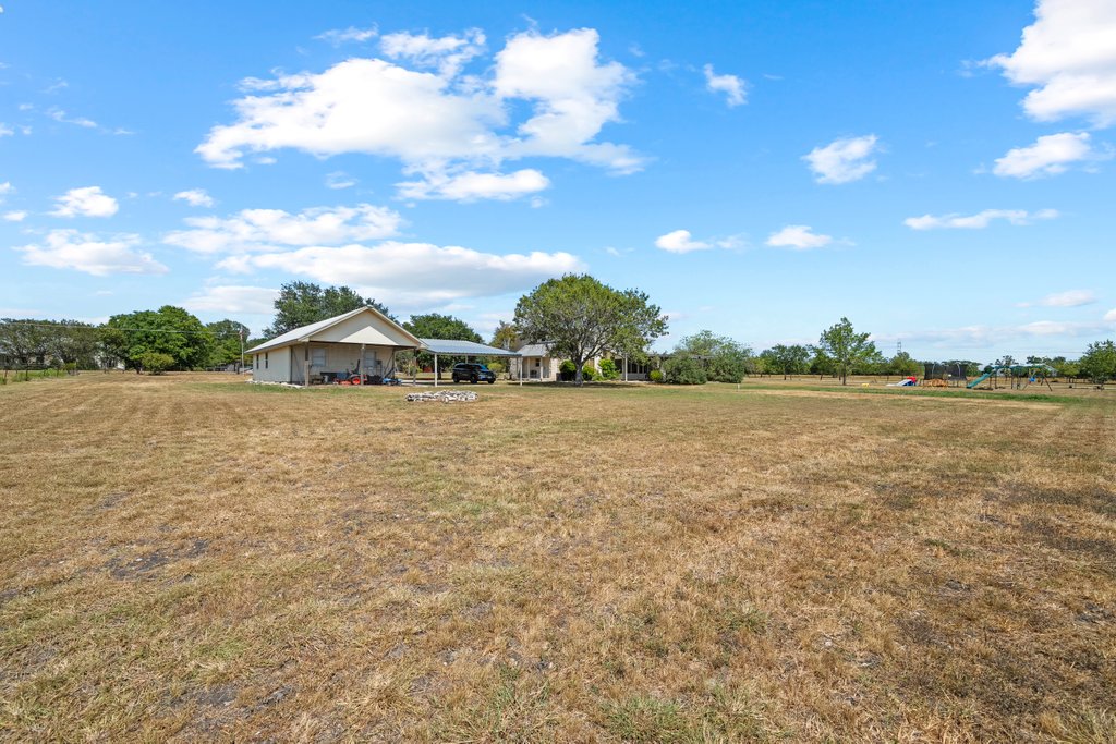 1100 Martindale Falls Road Martindale, TX 78655 - Photo 22 of 31 View of green lawn featuring a view of rural / pastoral area