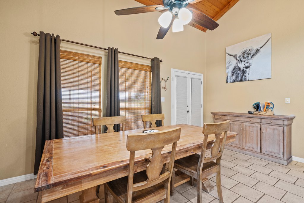1100 Martindale Falls Road Martindale, TX 78655 - Photo 6 of 31 Dining area featuring high vaulted ceiling, light tile patterned floors, ceiling fan, and wooden ceiling