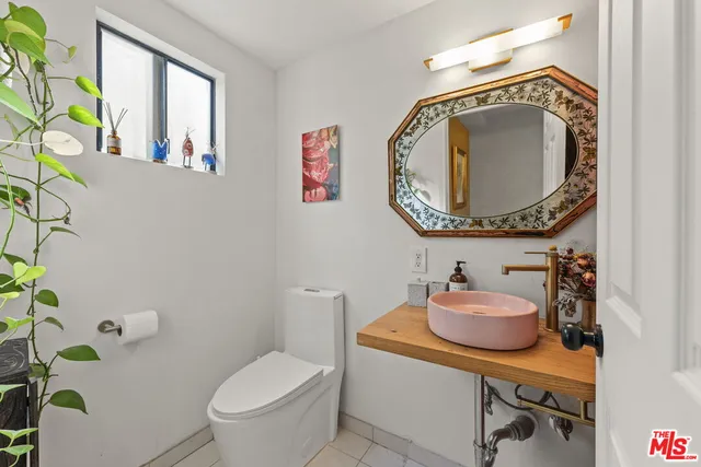 a bathroom with a toilet a sink and a mirror