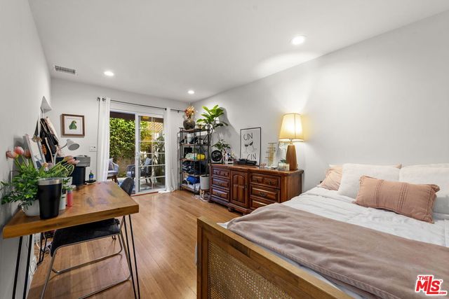 a view of a patio with table and chairs and potted plants