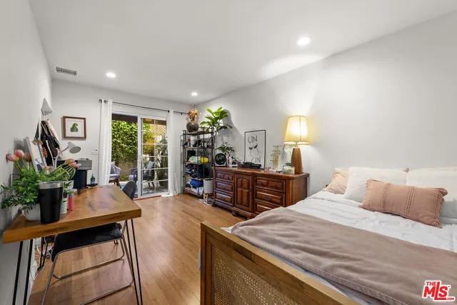 a view of a patio with table and chairs and potted plants