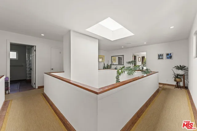 a bedroom with two beds and a painting on the wall