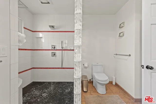 a bedroom with a bed and windows