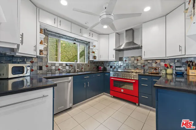 a kitchen with stainless steel appliances granite countertop a sink dishwasher stove and refrigerator