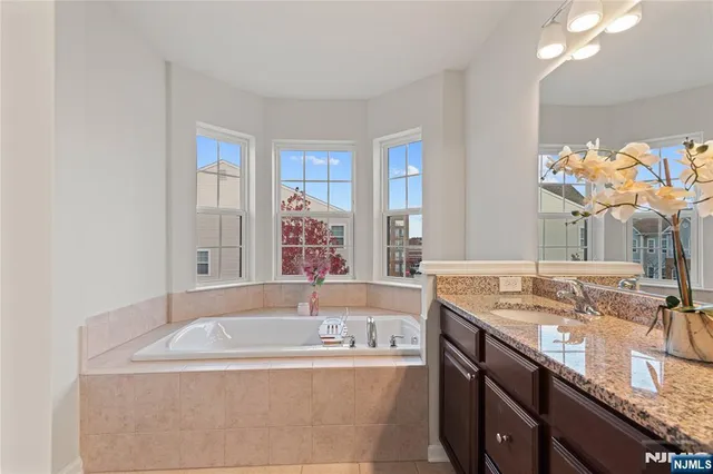 a bath tub sitting next to a bathroom sink