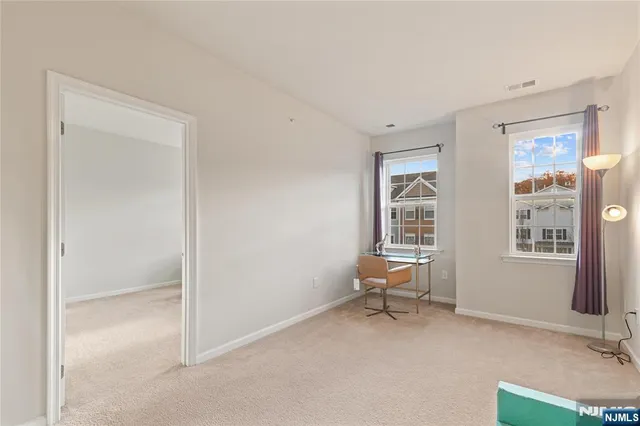 a view of a livingroom with lounge chair and a window