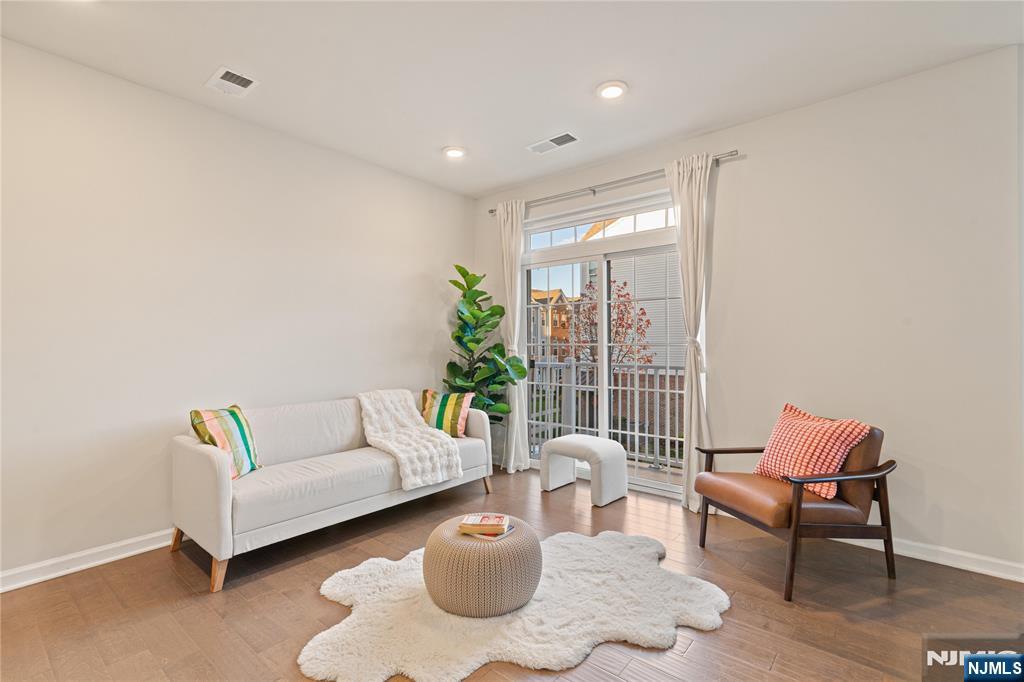 43 Wesmont Drive, Unit 1712 Wood-Ridge, NJ 07075 - Photo 5 of 35 a living room with furniture and a floor to ceiling window