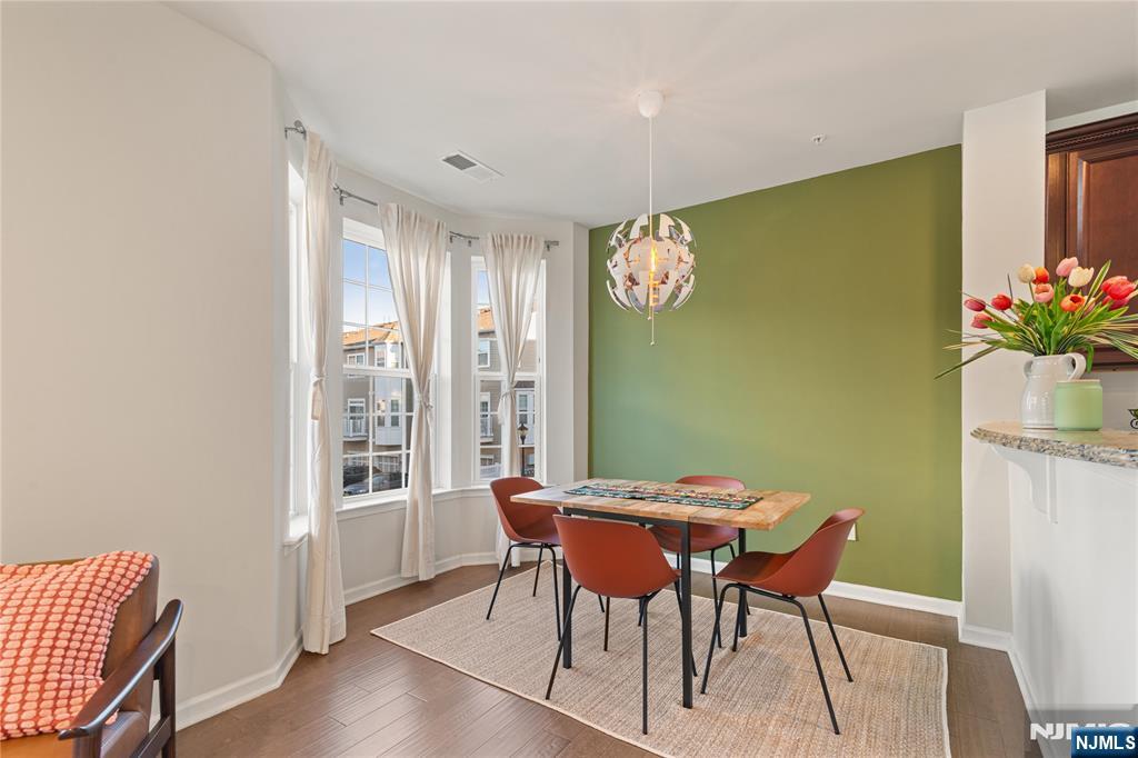 43 Wesmont Drive, Unit 1712 Wood-Ridge, NJ 07075 - Photo 6 of 35 a view of a dining room with furniture window and wooden floor