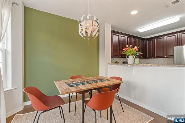 a view of a dining room with furniture and chandelier