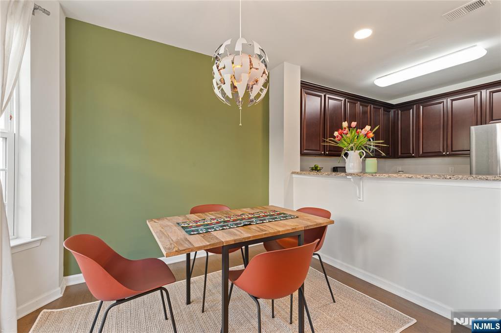 43 Wesmont Drive, Unit 1712 Wood-Ridge, NJ 07075 - Photo 7 of 35 a view of a dining room with furniture and chandelier