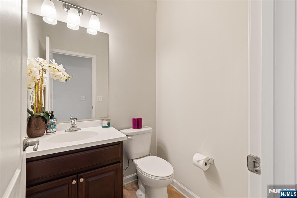 43 Wesmont Drive, Unit 1712 Wood-Ridge, NJ 07075 - Photo 10 of 35 a bathroom with a sink vanity mirror and toilet