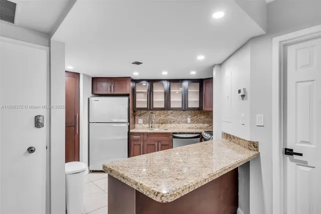 a kitchen with a stove and refrigerator