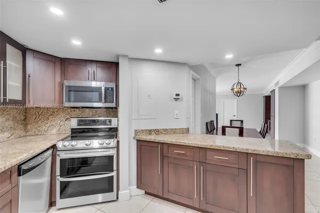a kitchen with kitchen island granite countertop stainless steel appliances and sink