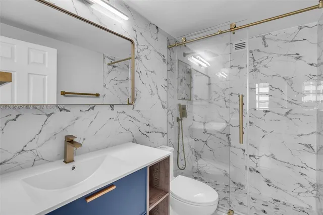 a bathroom with a sink toilet and shower