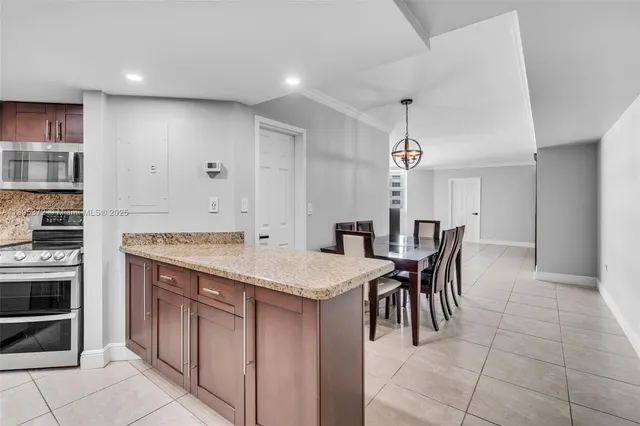 a kitchen with a stove a refrigerator and a dining table