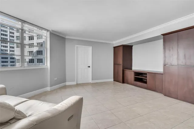 a living room with a couch and a refrigerator