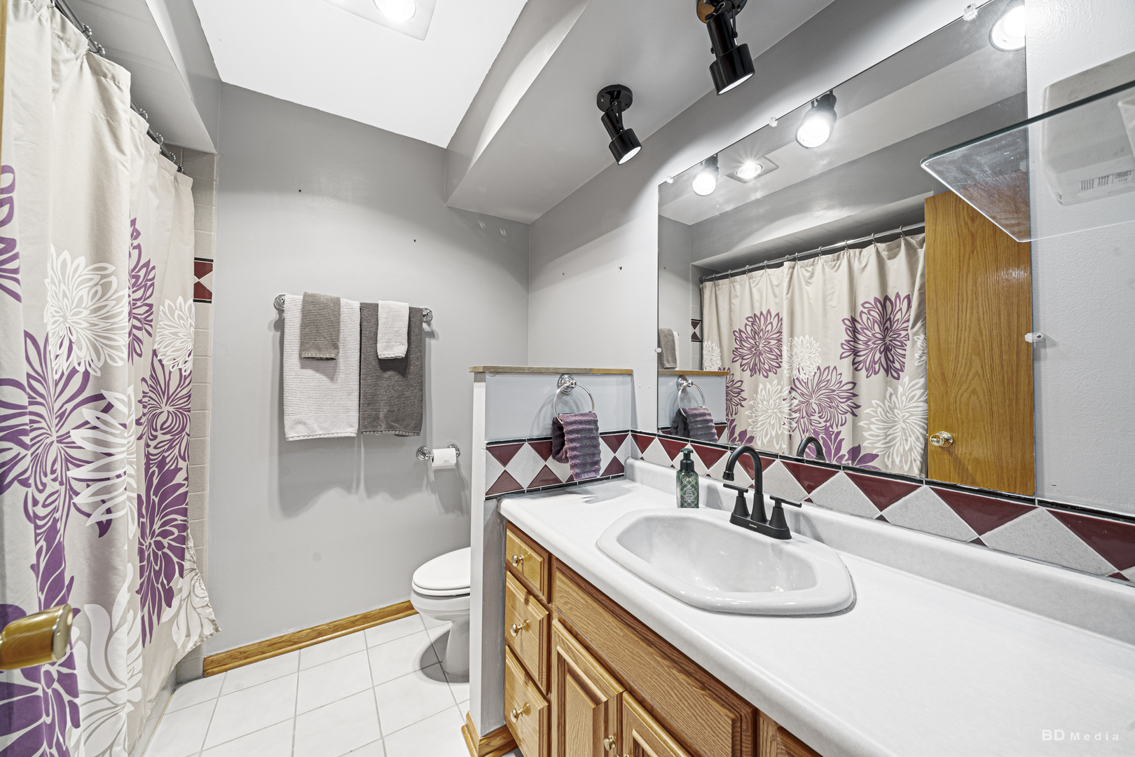 807 Maple Lane Peotone, IL 60468 - Photo 16 of 33 a bathroom with double vanity sink a mirror and a shower