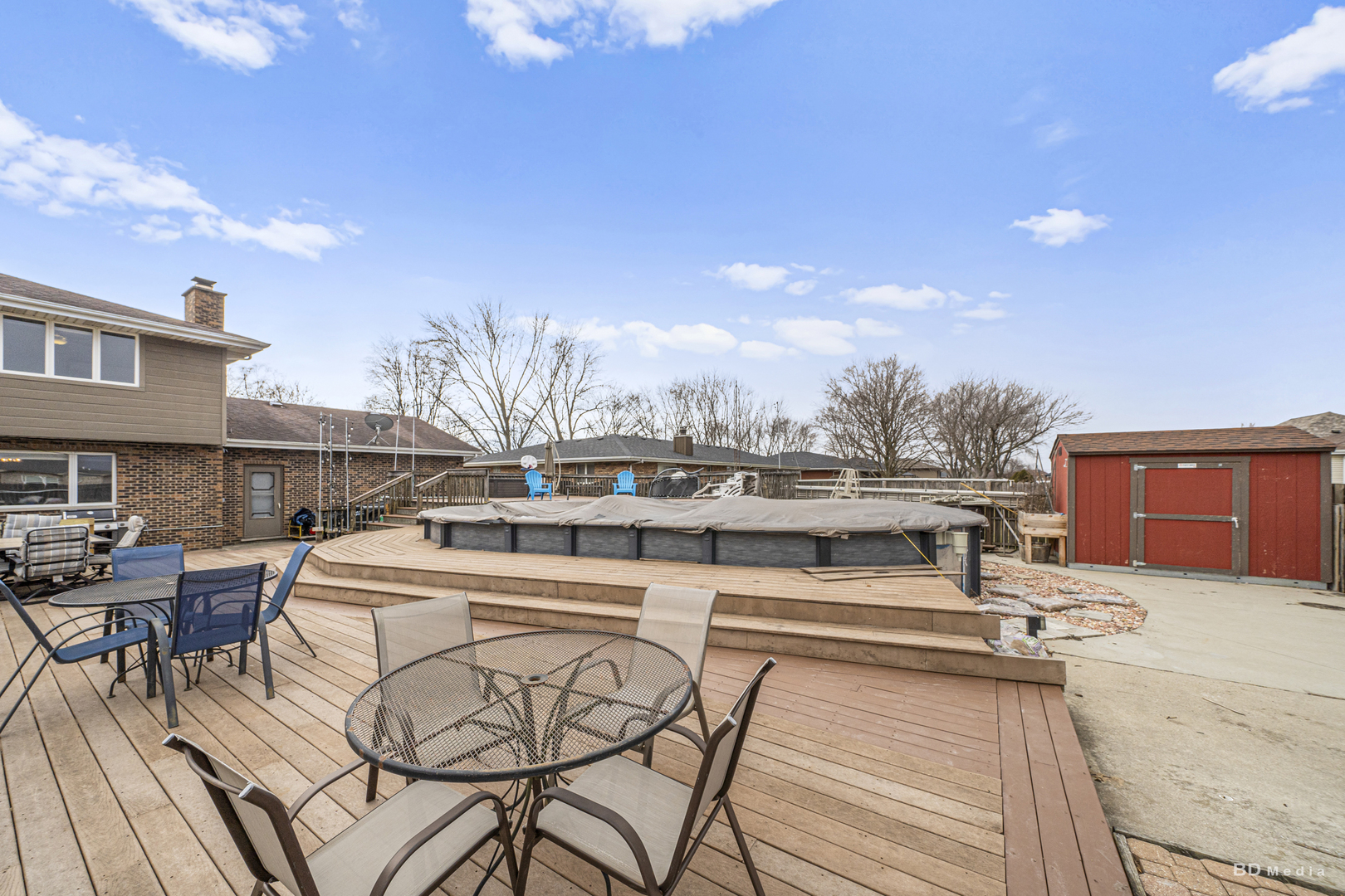 807 Maple Lane Peotone, IL 60468 - Photo 32 of 33 a view of a patio with dining table and chairs with wooden floor