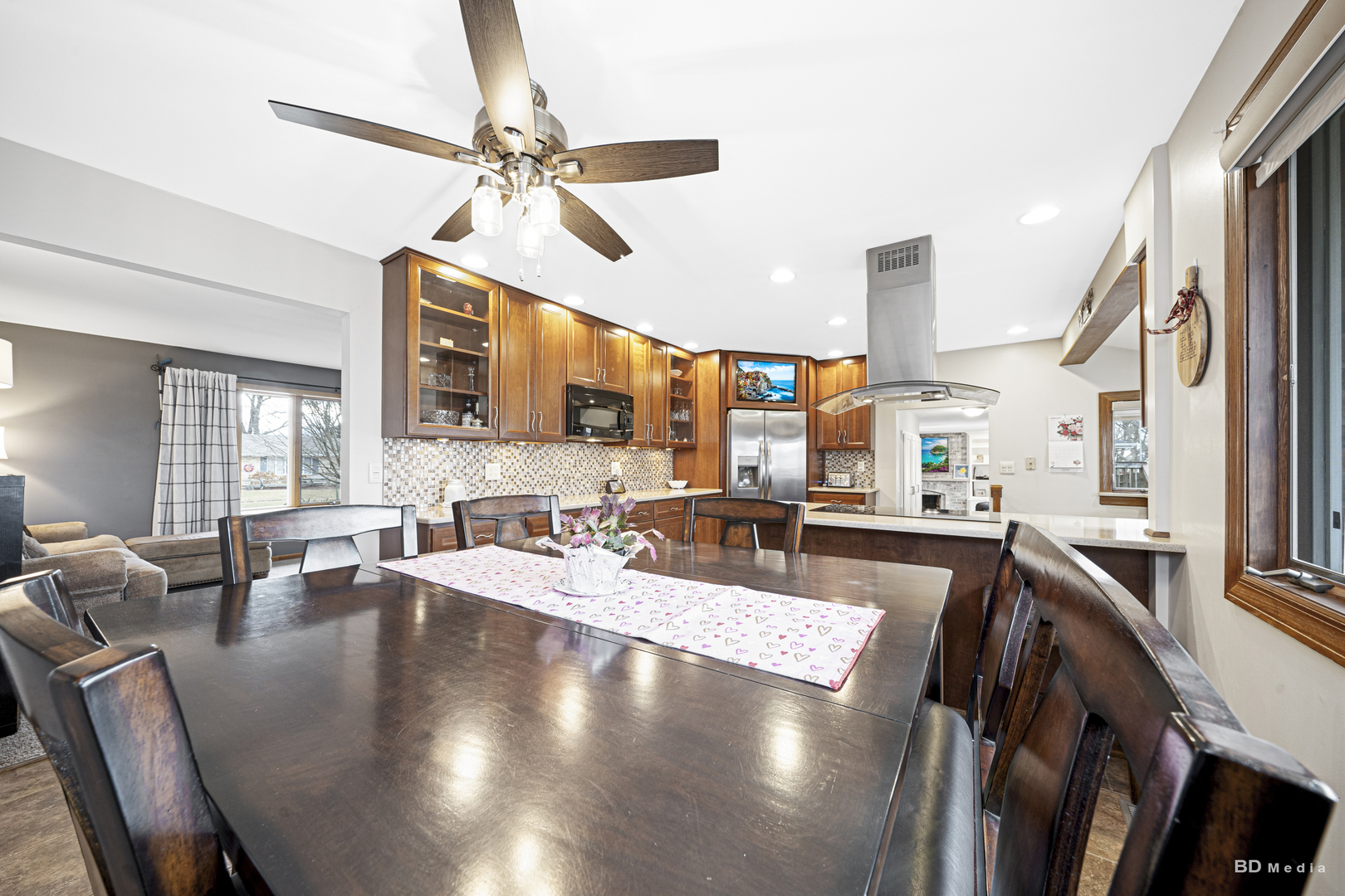 807 Maple Lane Peotone, IL 60468 - Photo 9 of 33 a view of a dining room and livingroom with furniture wooden floor a chandelier