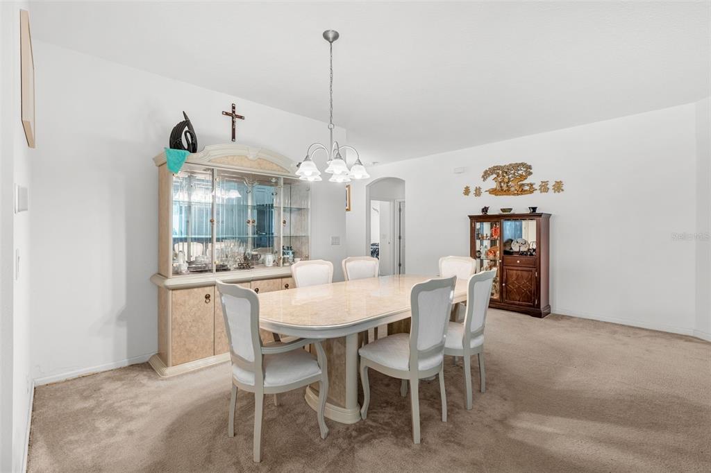 2085 Lula Road Minneola, FL 34715 - Photo 13 of 39 a view of a dining room with furniture and chandelier