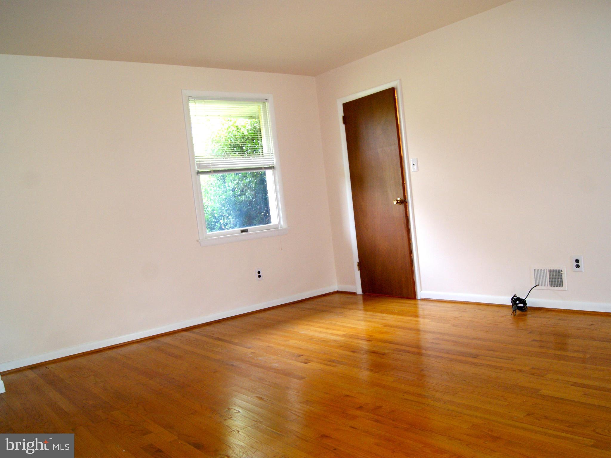 9221 Cornflower Road Baltimore, MD 21236 - Photo 15 of 25 an empty room with wooden floor and windows