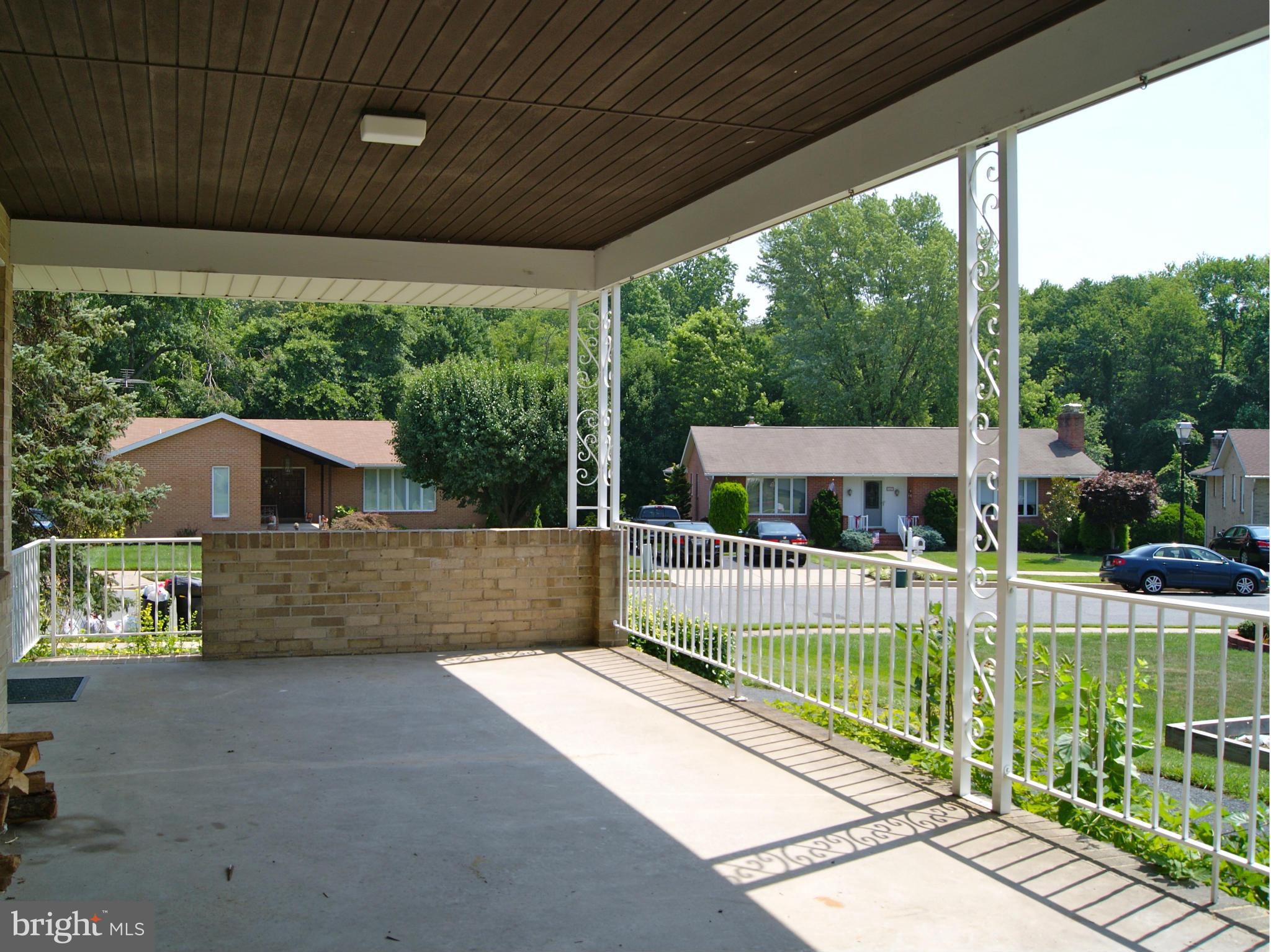 9221 Cornflower Road Baltimore, MD 21236 - Photo 3 of 25 a view of a deck with a floor to ceiling window next to a yard