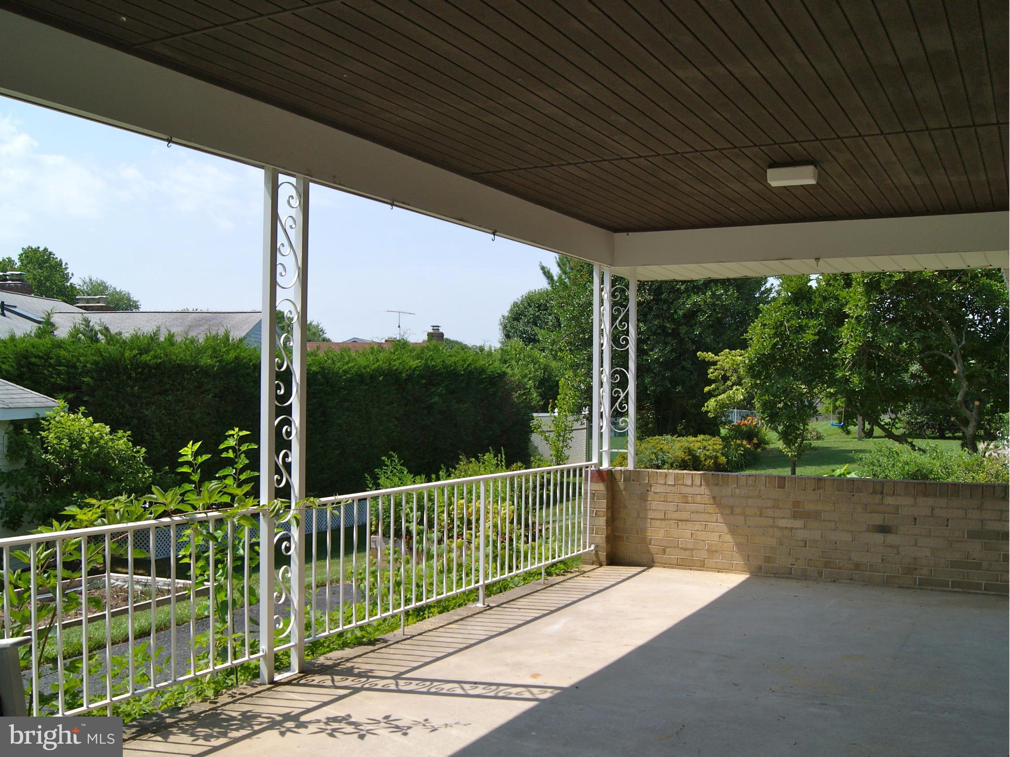 9221 Cornflower Road Baltimore, MD 21236 - Photo 4 of 25 a view of a deck with a floor to ceiling window and wooden fence