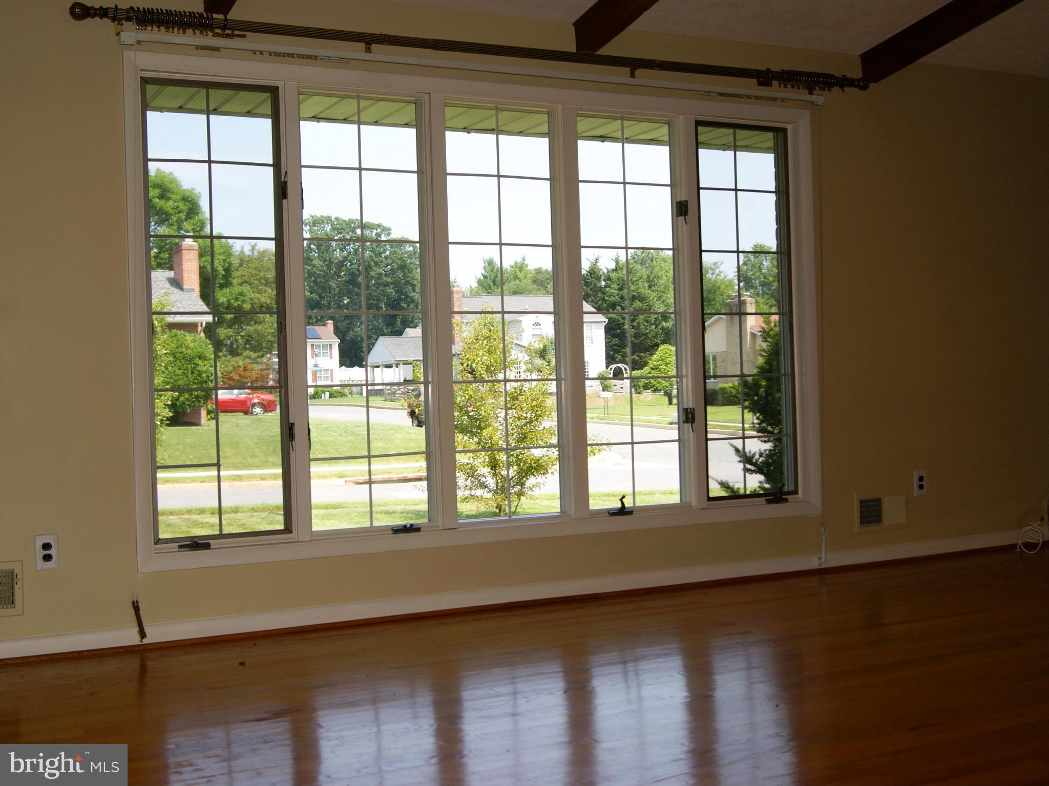9221 Cornflower Road Baltimore, MD 21236 - Photo 8 of 25 a view of wooden floor and windows in a room