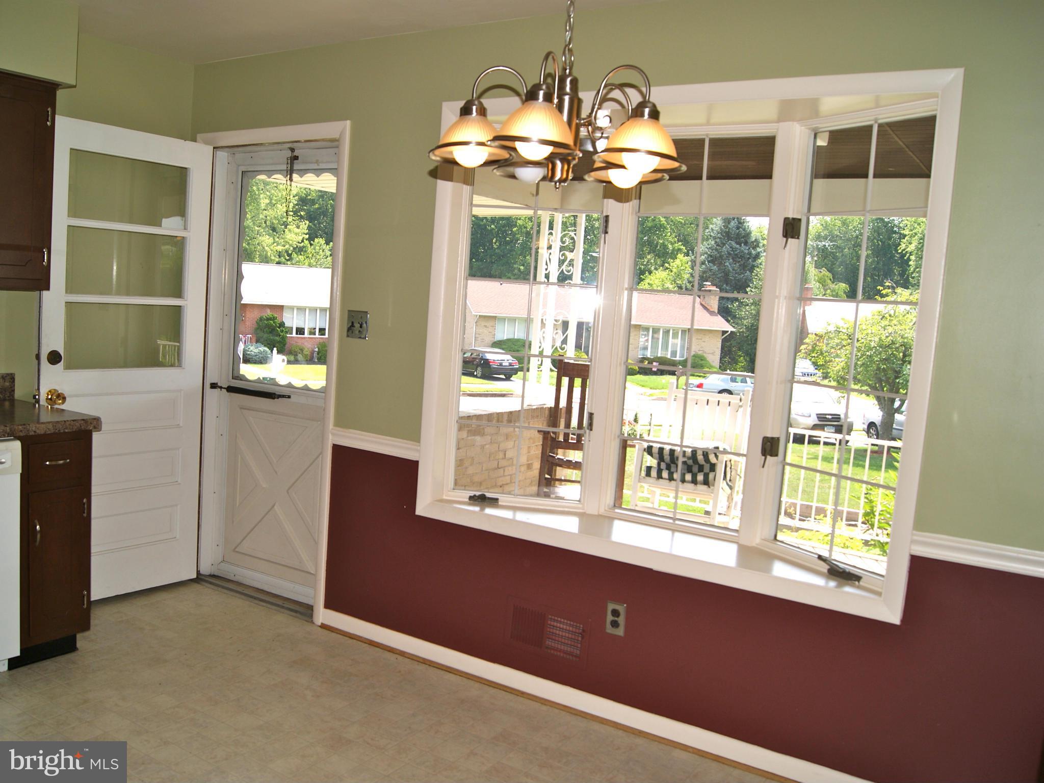 9221 Cornflower Road Baltimore, MD 21236 - Photo 10 of 25 a dining room with wooden floor chandelier and windows
