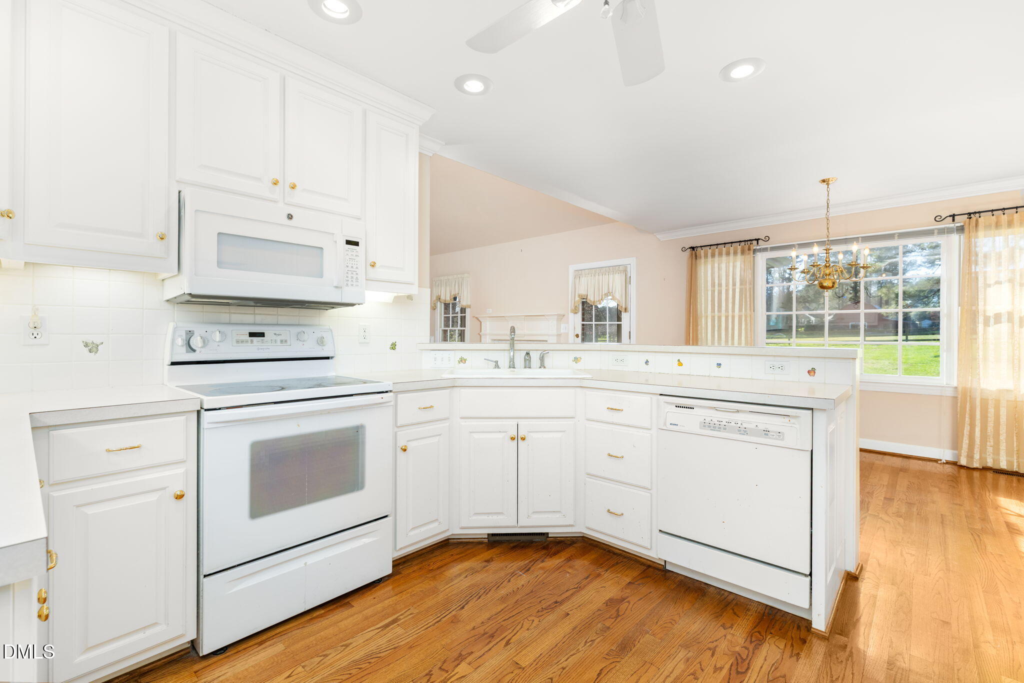 4076 Salem Farm Road Oxford, NC 27565 - Photo 16 of 55 a kitchen with white cabinets appliances and wooden floor